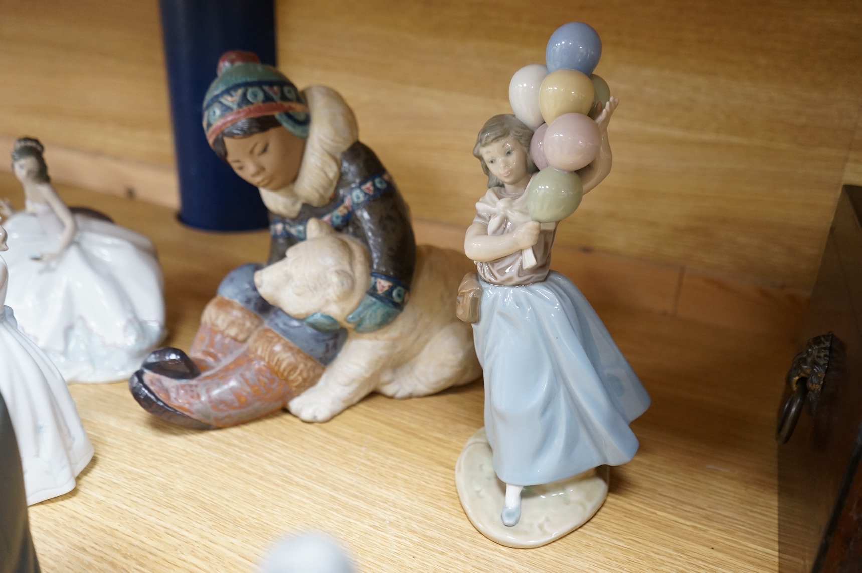 A collection of Lladro to including an eskimo and polar bear group, 23cm high (9)